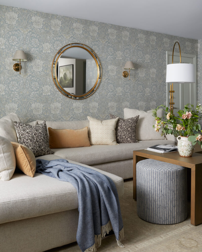 Living room designed with wallpaper and statement mirror